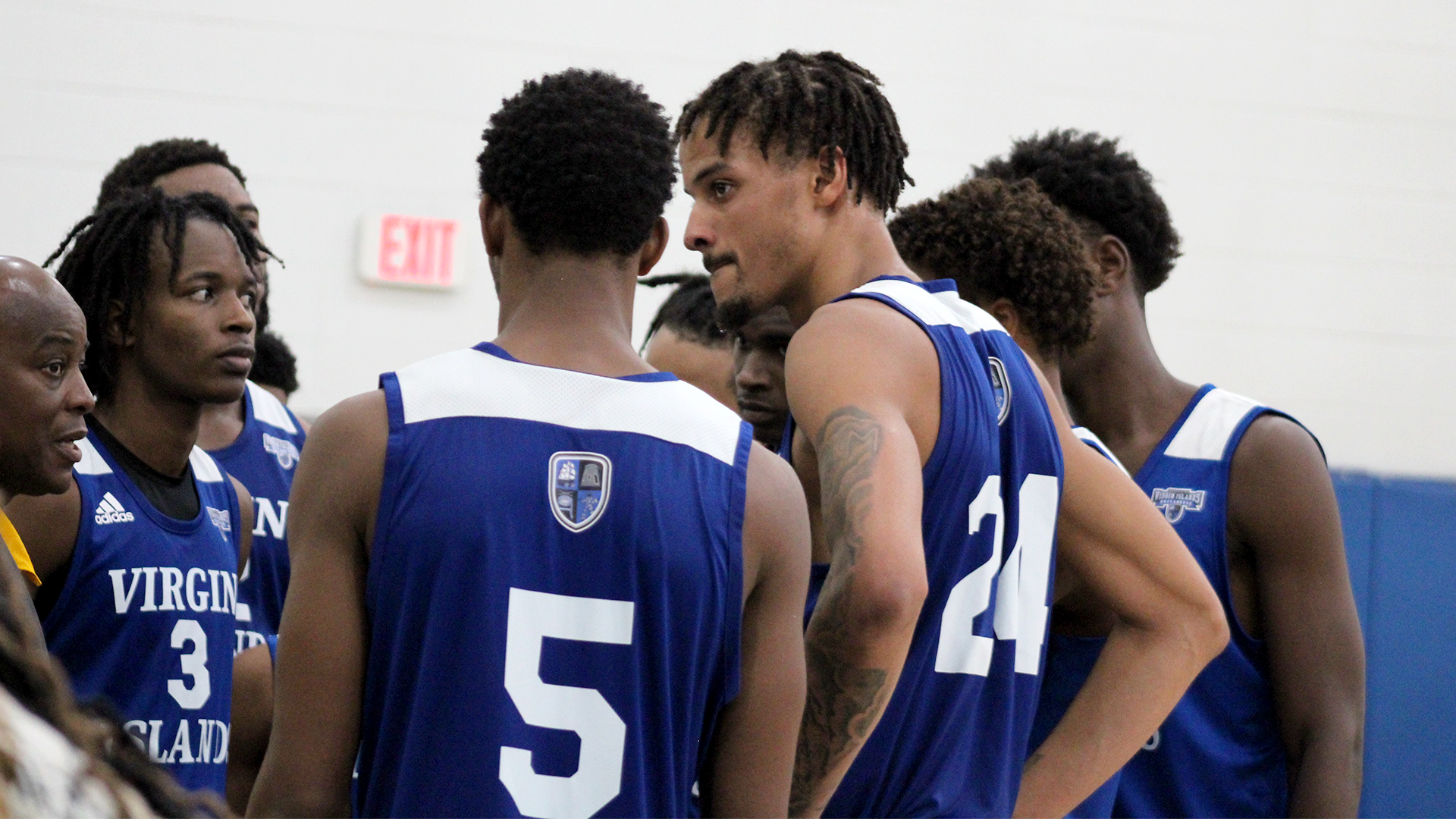 Will Boyd (24) listening in the huddle as Head Coach Alfonzo Duncan speaks.